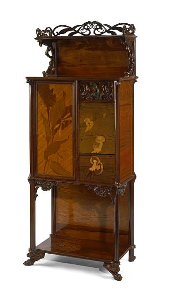 Appraisal: An Art Nouveau style carved walnut cabinet in the manner