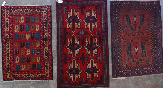 Appraisal: THREE AFGHAN BELOUCHI TRIBAL AREA RUGS all hand knotted wool