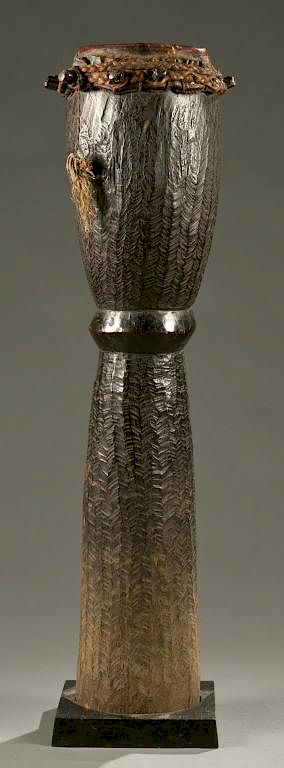 Appraisal: African drum with hide top th c An hour-glass shaped