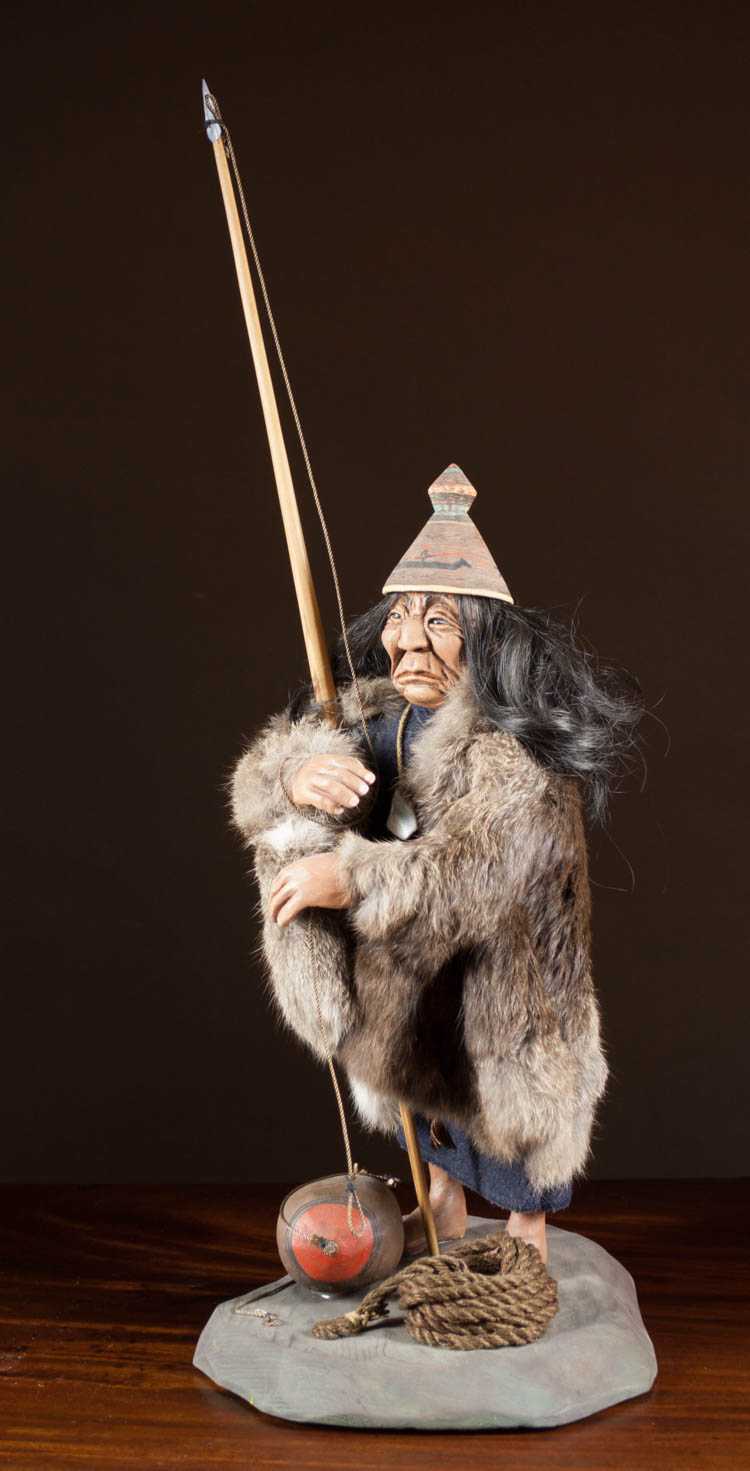 Appraisal: NATIVE AMERICAN SHONAHA DOLL depicting a standing fisherman with fur