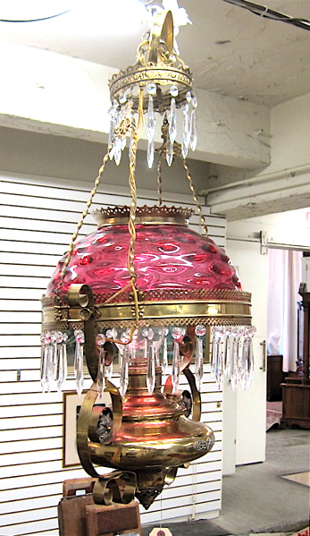 Appraisal: VICTORIAN BRASS AND CRANBERRY GLASS HANGING KEROSENE LAMP Edward Miller