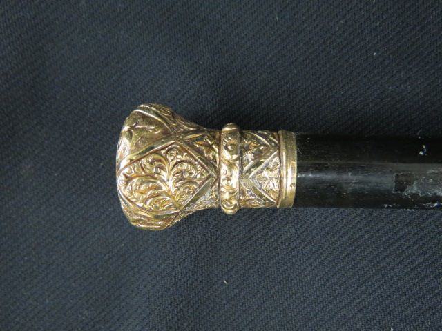 Appraisal: Victorian Walking Stick ornate gold-filled carved handle ebonized wood long