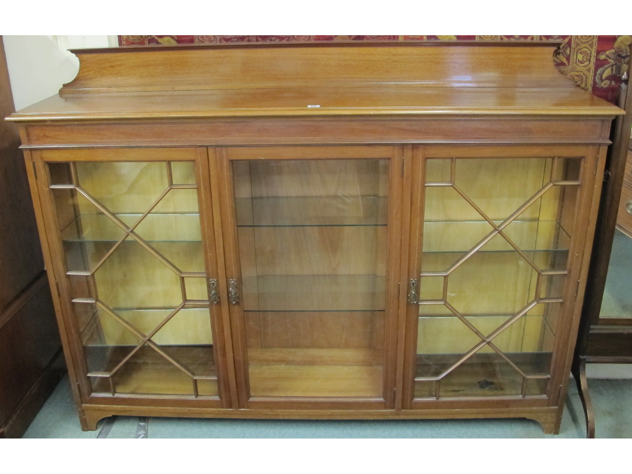 Appraisal: An Edwardian mahogany astragal glazed display cabinet