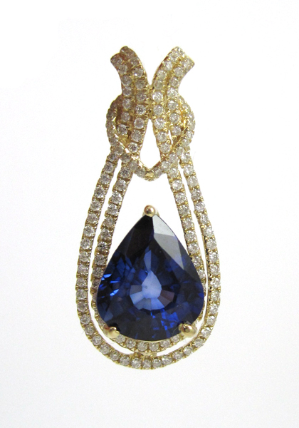 Appraisal: SAPPHIRE AND FOURTEEN KARAT GOLD PENDANT with round-cut diamonds set