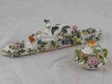 Appraisal: A miniature bowl and cover encrusted with flowers underglaze crossed