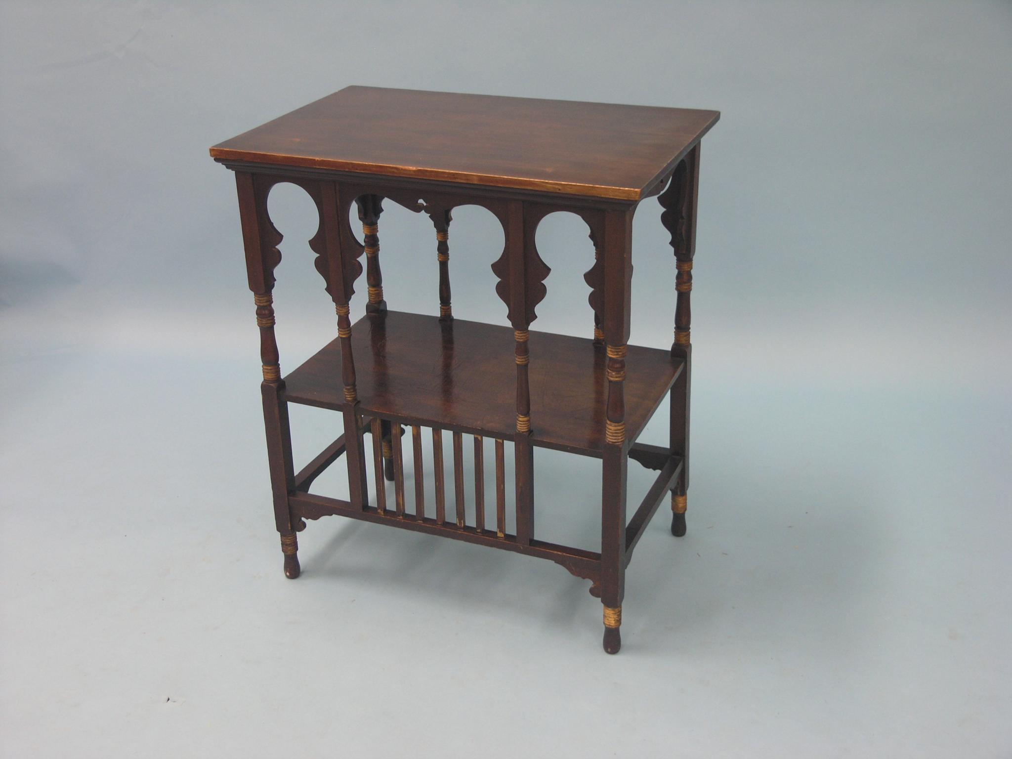 Appraisal: A late Victorian mahogany occasional table two-tiered with shaped slats