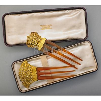 Appraisal: TWO FLORENTINE STYLE GOLD COMBS IN TIFFANY BOX Pierced and