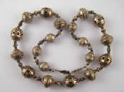 Appraisal: A white metal tests silver Eastern necklace largest bead approx