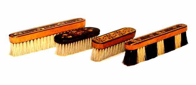 Appraisal: FOUR TUNBRIDGEWARE CLOTHES BRUSHES three with inset flower design and