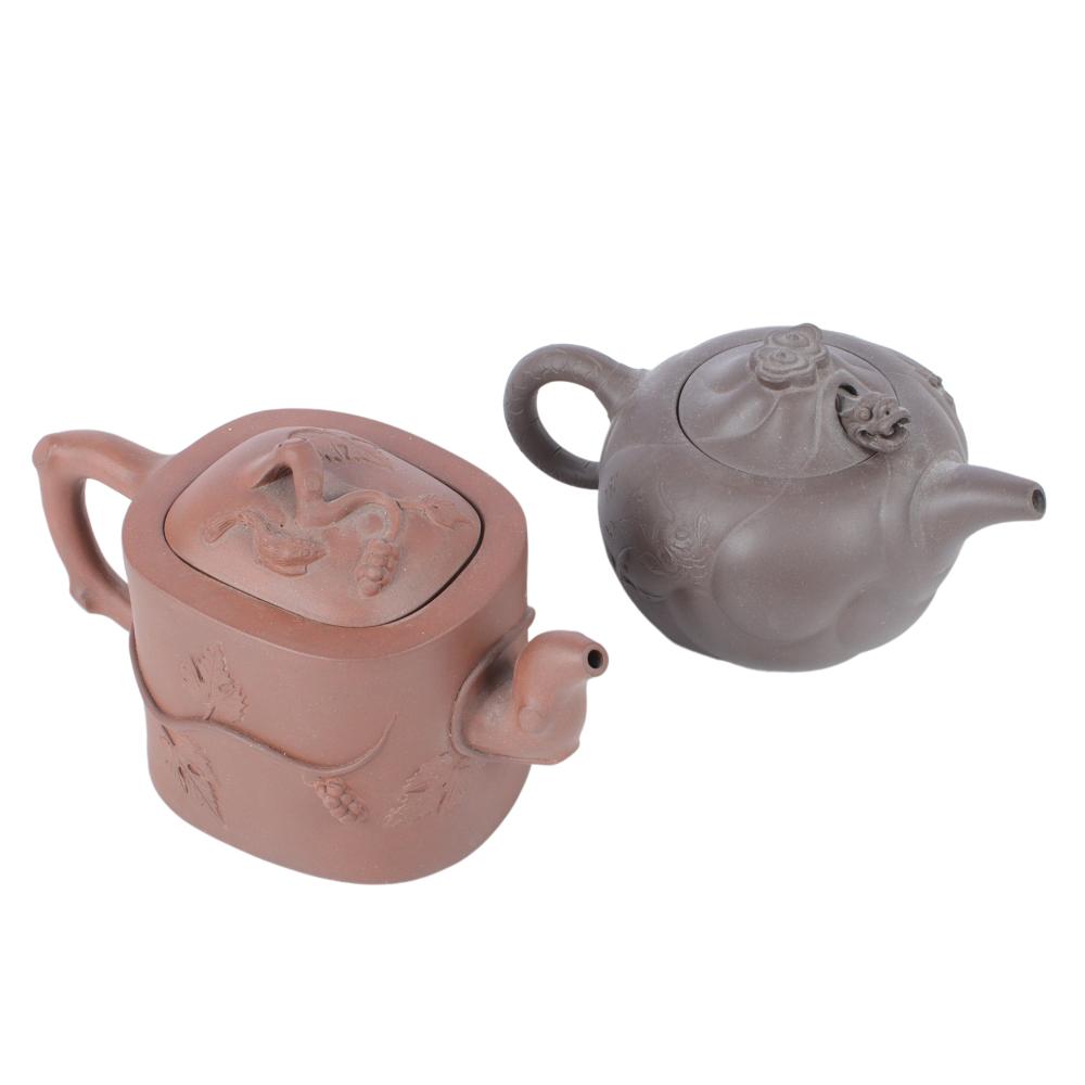 Appraisal: TWO CHINESE YIXING CLAY POTTERY TEAPOTS DRAGON MOTIF AND VINING