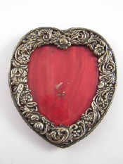 Appraisal: A late Victorian silver faced heart shaped photo frame with