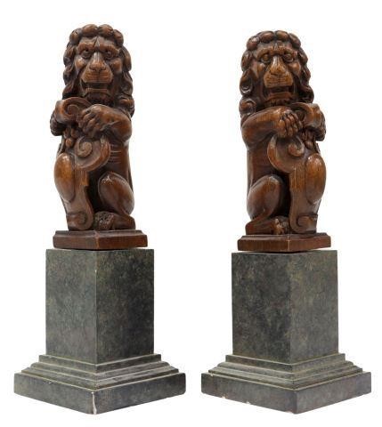 Appraisal: pair Carved walnut garnitures rearing lion with forepaws on a