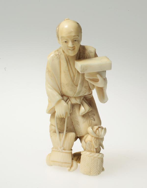 Appraisal: JAPANESE IVORY OKIMONO OF A MAN CARRYING SHOPPING Meiji period