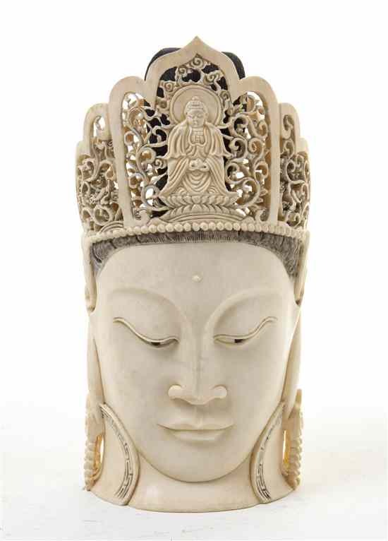 Appraisal: A Chinese Carved Ivory Buddha Head wearing a crown pierce