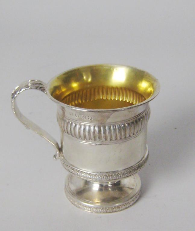 Appraisal: A George III pedestal Christening Mug with leafage scroll handle