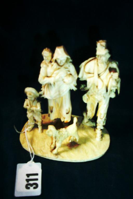 Appraisal: A carved ivory figure of a family and their dog