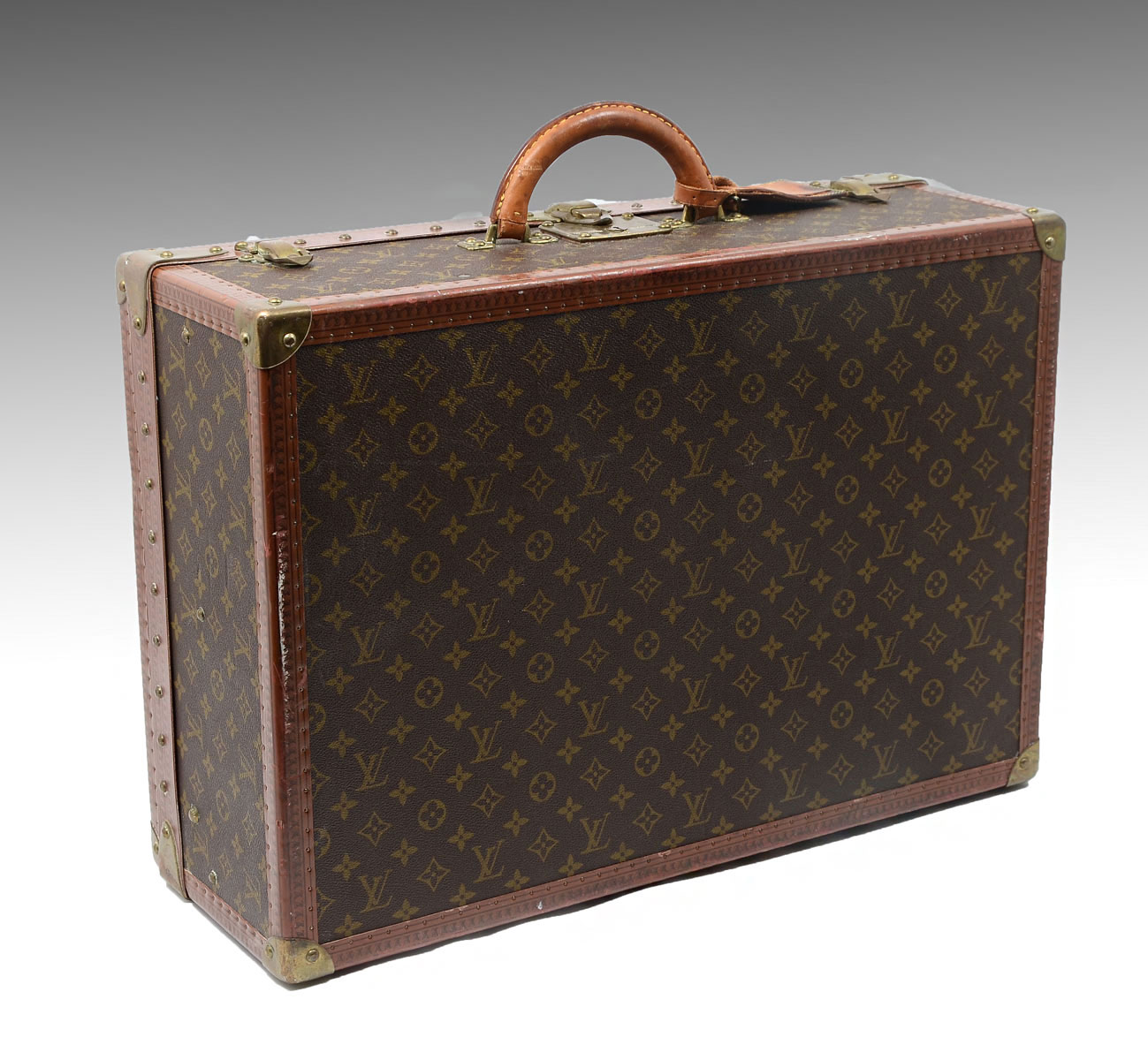 Appraisal: RARE LARGE VINTAGE LOUIS VUITTON SUITCASE Canvas and leather hard