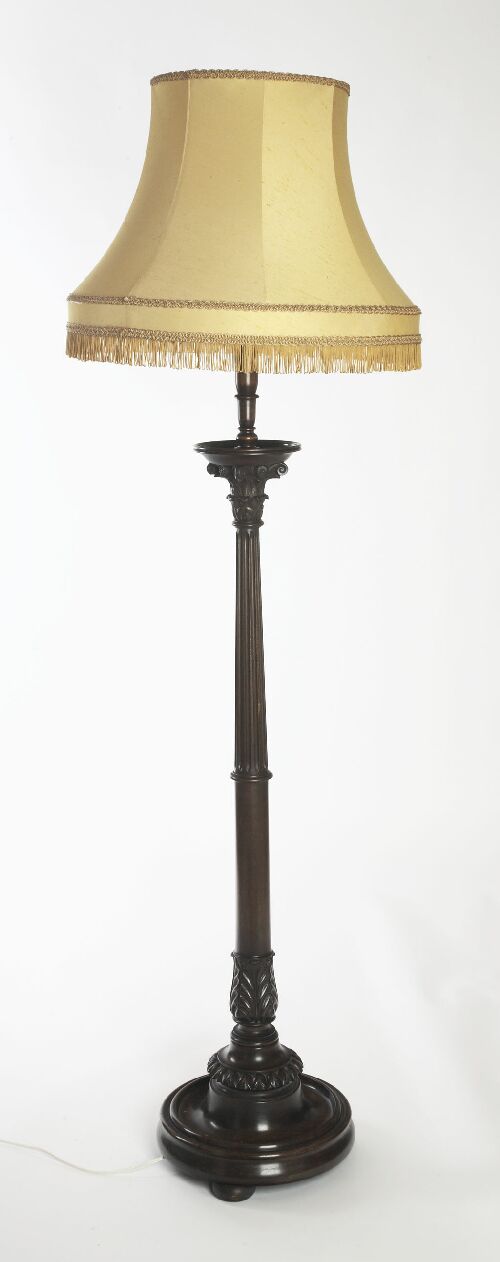 Appraisal: A mahogany standard lamp with turned column above dished top