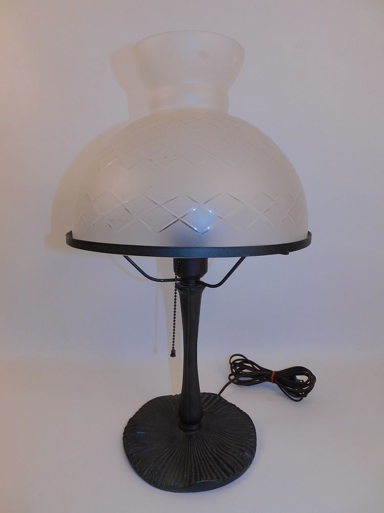 Appraisal: ANTIQUE ELECTRIC LAMP CUT SHADE Antique bronze or patinated metal