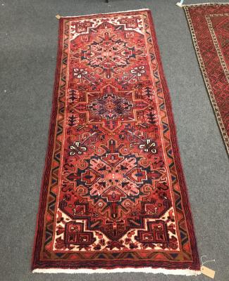 Appraisal: A Heriz rug the red ground with three medallions to