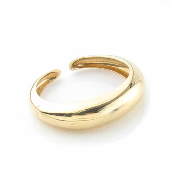 Appraisal: A fourteen karat yellow gold domed cuff bangle with single