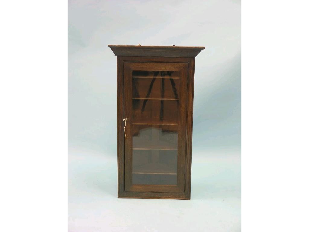 Appraisal: A small Victorian dark oak corner cabinet single glazed door