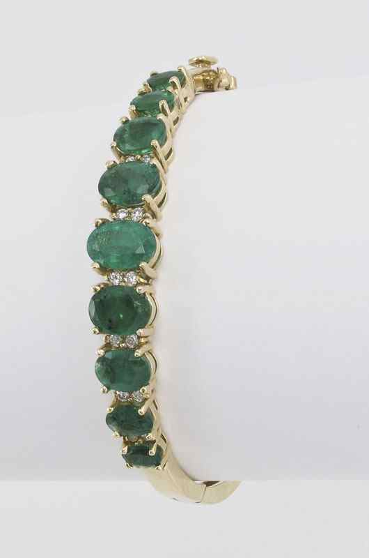 Appraisal: EMERALD AND DIAMOND BRACELET K yellow gold bracelet of oval