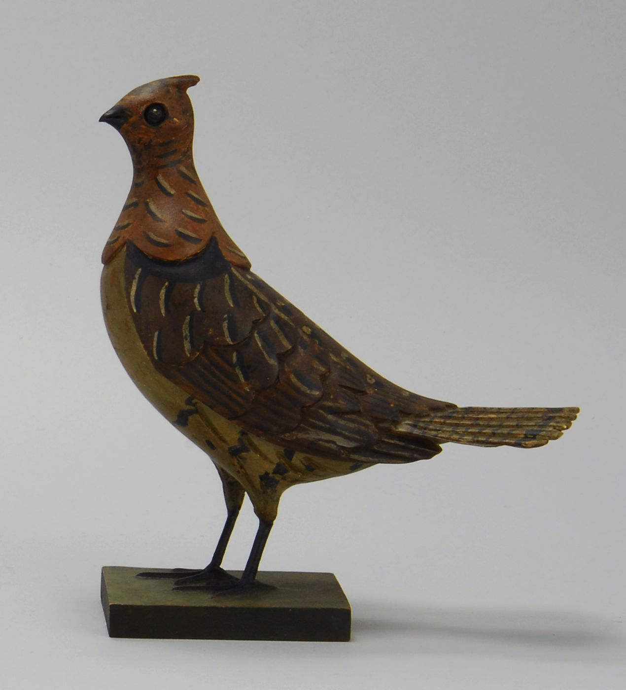 Appraisal: MINIATURE CARVING OF A RUFFED GROUSE Circa By Carl Forstund