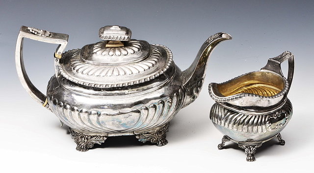 Appraisal: A GEORGE IV SILVER TEAPOT oval shaped with fluted lower