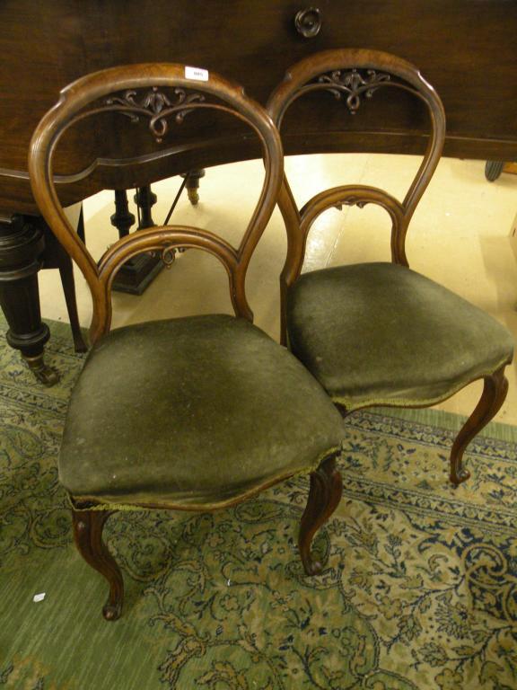 Appraisal: A pair of Victorian walnut balloon back dining chairs