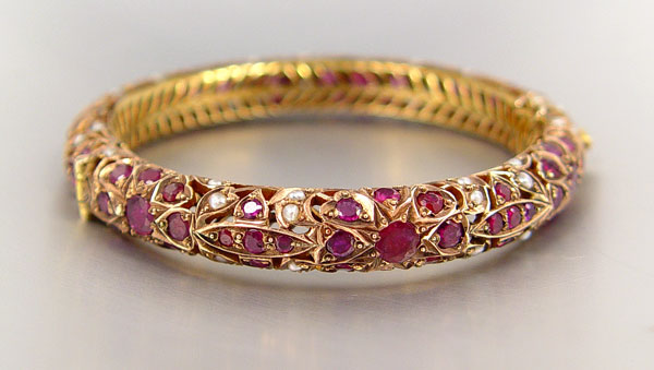 Appraisal: K RUBY AND SEED PEARL BANGLE BRACELET K yellow gold