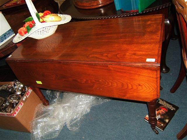 Appraisal: A Victorian mahogany Pembroke table on turned legs standing on