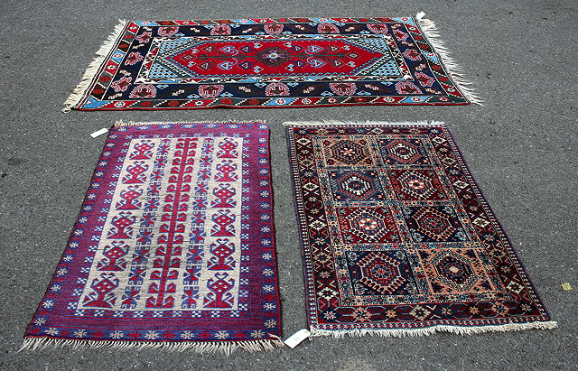 Appraisal: A MIDDLE EASTERN RED AND BLUE GROUND RUG with multiple