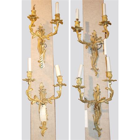 Appraisal: Set of Four Louis XV Style Gilt-Bronze Two-Light Sconces Estimate