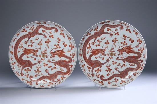 Appraisal: PAIR CHINESE IRON RED AND GILT PORCELAIN DRAGON CHARGERS Guangxu