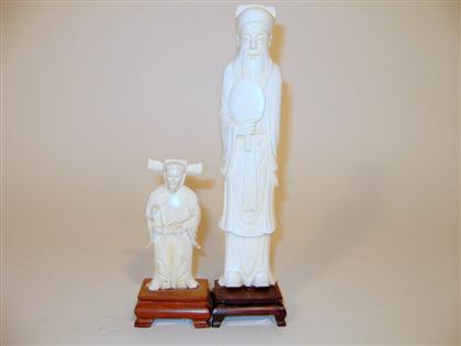 Appraisal: Two Chinese elephant ivory models The tallest standing holding a