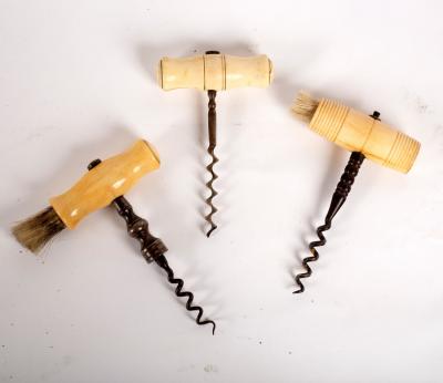 Appraisal: A steel corkscrew with ivory handle and brush another with