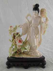 Appraisal: A very finely carved and tinted ivory figure of a