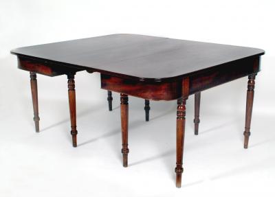 Appraisal: A REGENCY MAHOGANY DINING TABLE of rounded oblong form comprising