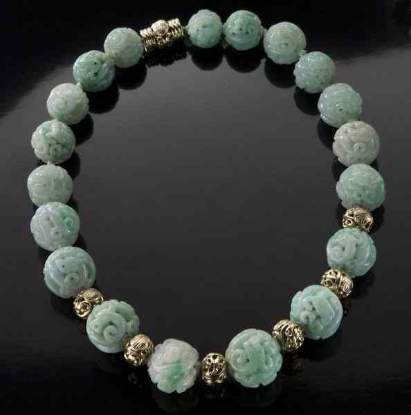 Appraisal: Chinese Qing K gold and carved jadeite necklace each intricately