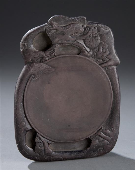 Appraisal: Chinese purple duan inkstone with carved dragon Having a dragon