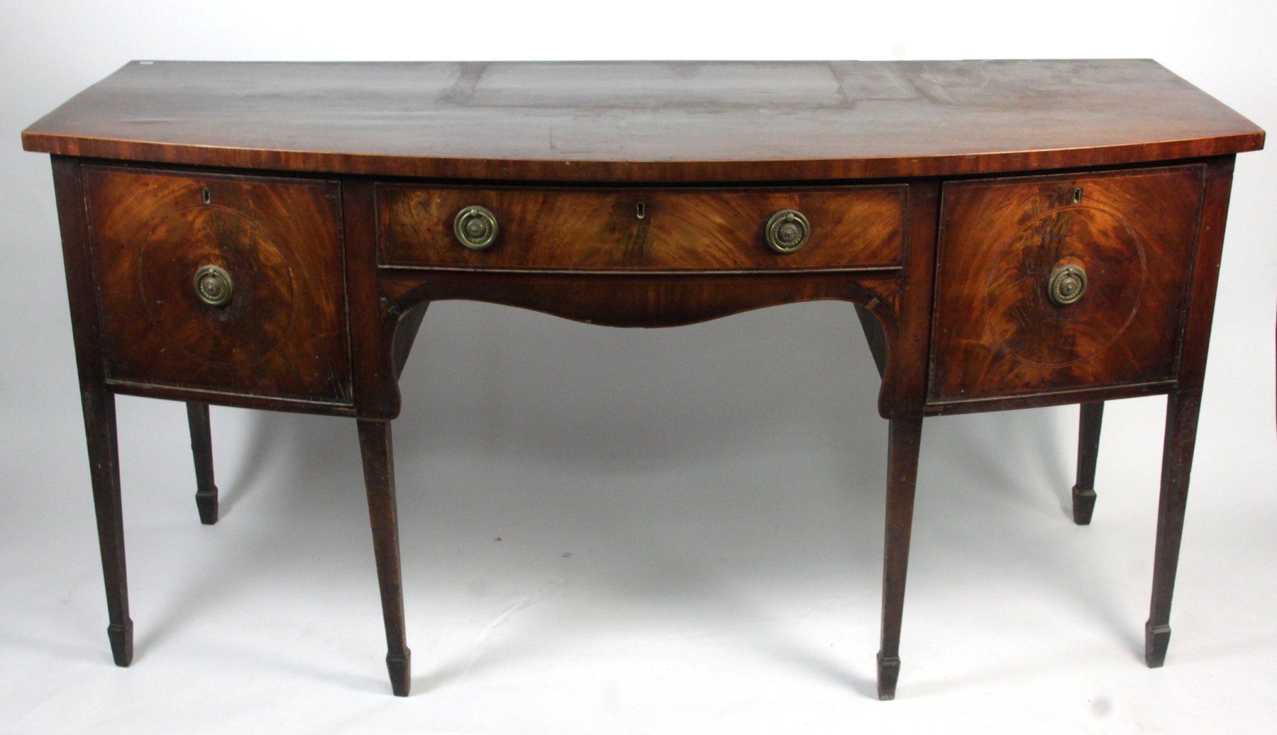 Appraisal: A George III bowfront mahogany sideboard the crossbanded top above