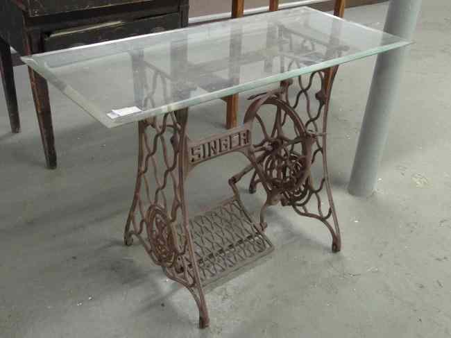 Appraisal: Sewing machine base glass top table