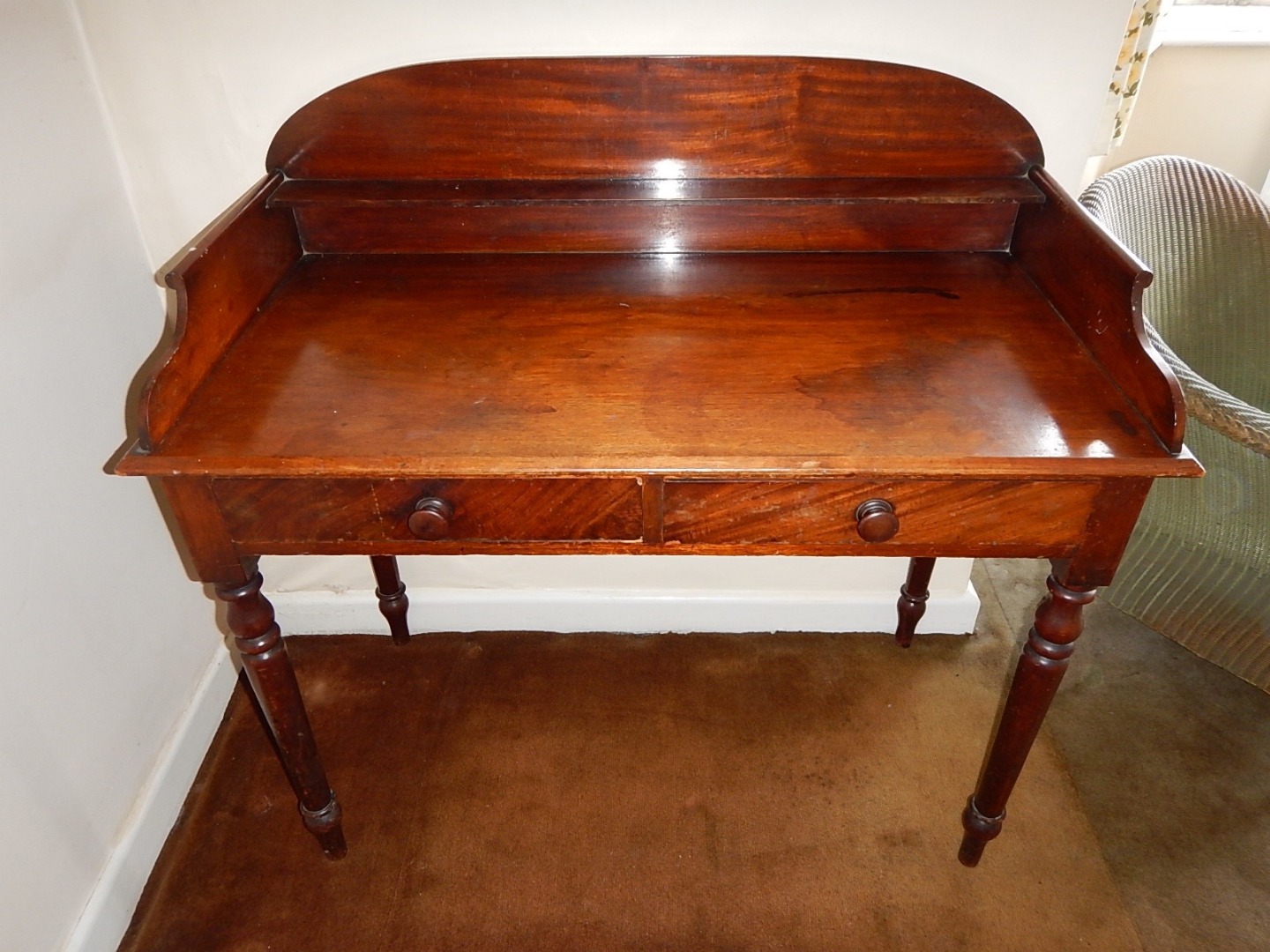 Appraisal: A Victorian figured mahogany washstand with low arched splashback and