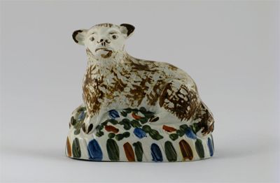 Appraisal: A Prattware model of a sheep recumbent upon a base