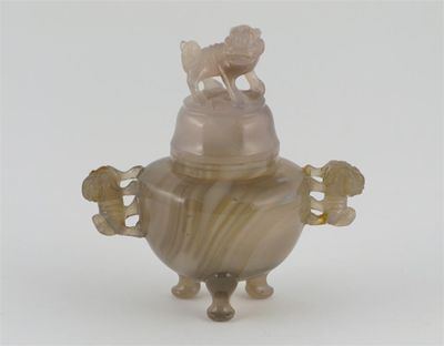 Appraisal: A Chinese agate tripod censer and cover carved with lion