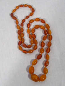 Appraisal: A mixed amber bead necklace approx cm long