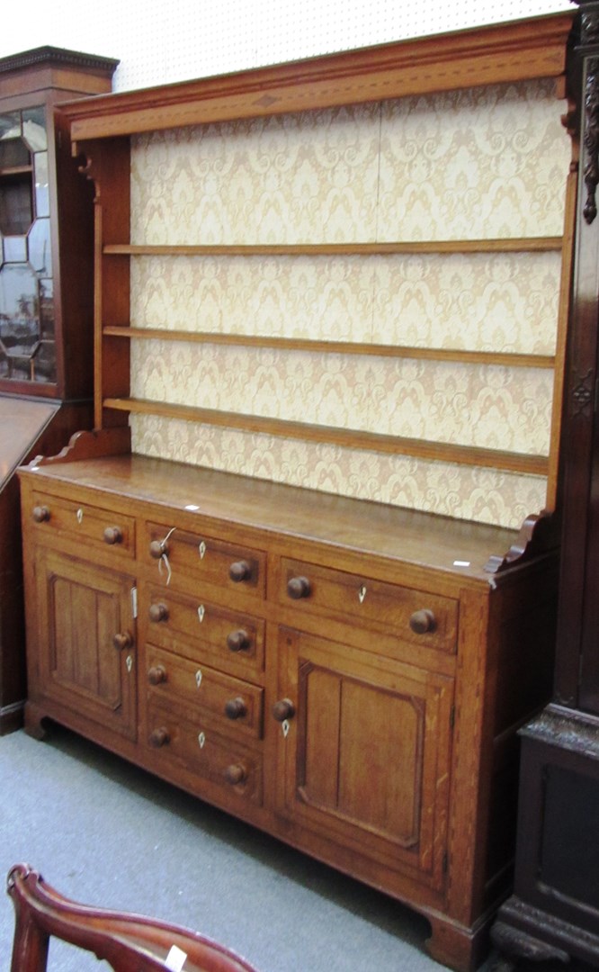 Appraisal: An th century style inlaid oak dresser the enclosed three