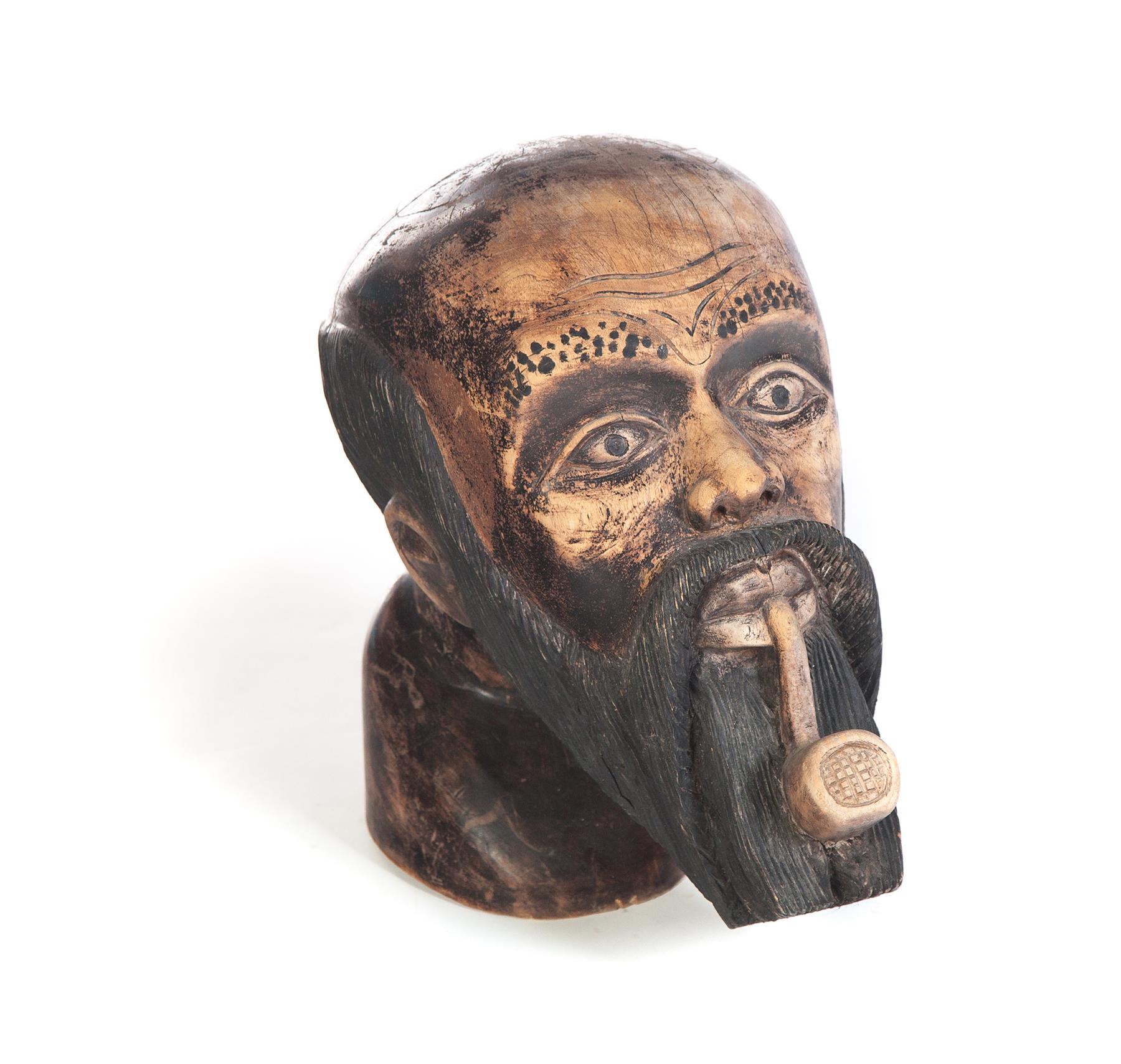 Appraisal: FOLKSY CARVED HEAD OF A MAN Twentieth century hardwood Bearded