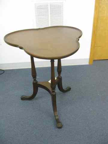 Appraisal: Mahogany Clover Top Table carved paw feet lower shelf